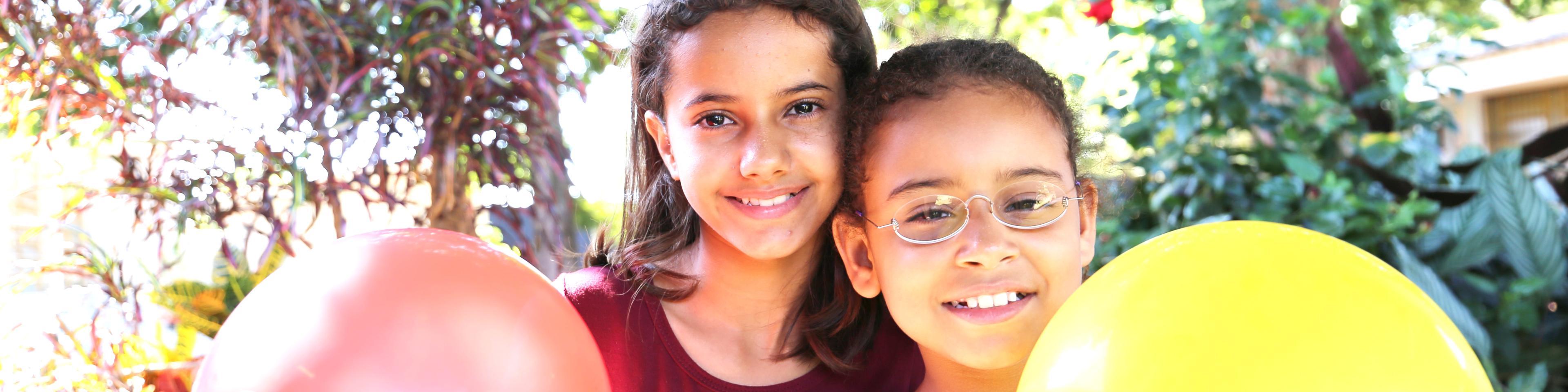 Two friends from Brazil, head to head, one wearing OneDollarGlasses